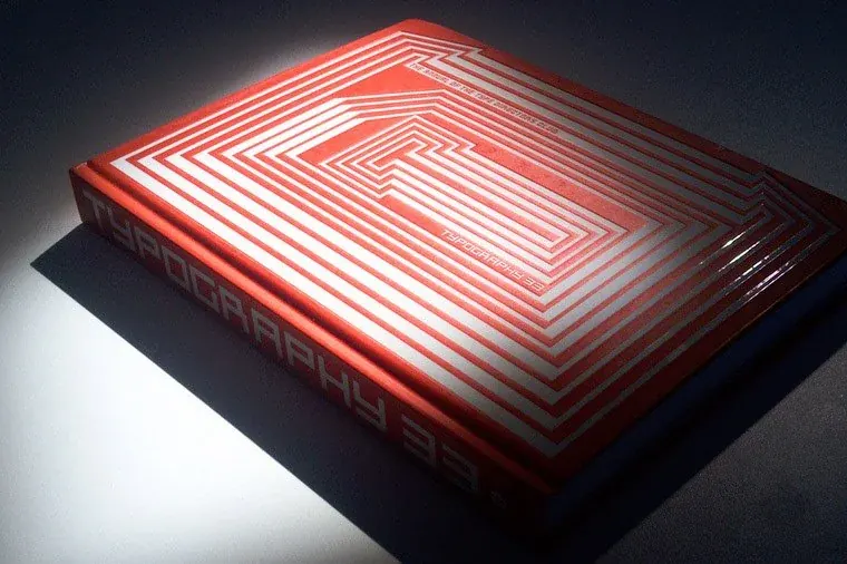 The Typography 35 annual, a red book with a concentric line pattern on the cover